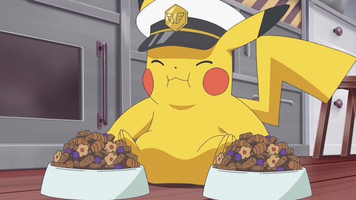 Pikachu, wearing a captain's hat, happily eats from two bowls of food.