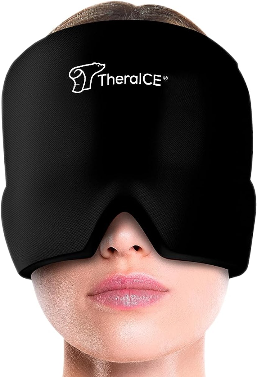 A close-up of a woman wearing a black TheraICE face mask, designed for cold therapy, showcasing a sl...