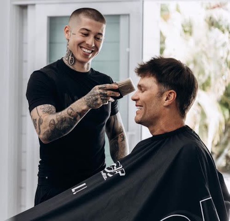 TikTok barber VicBlends giving Tom Brady a haircut