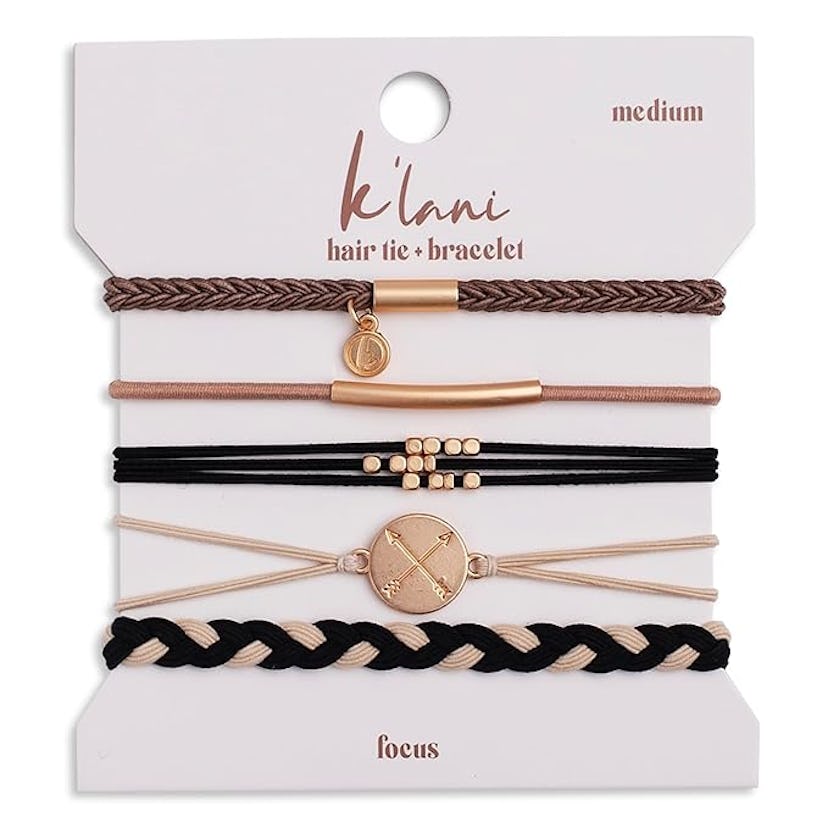 A flat display card featuring four hair ties that double as bracelets, in shades of black, brown, an...