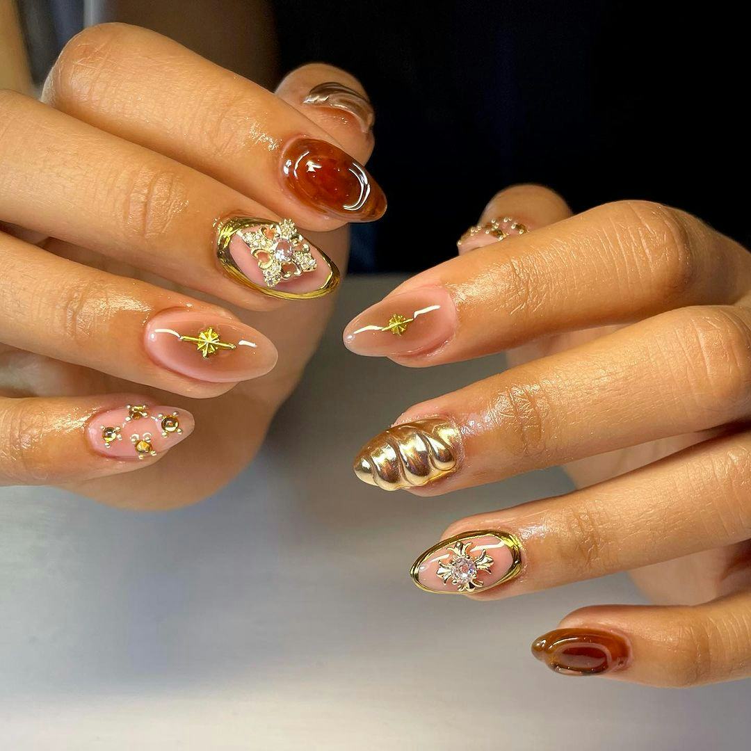 Brown nails with metallic accents are on-trend for fall 2024.