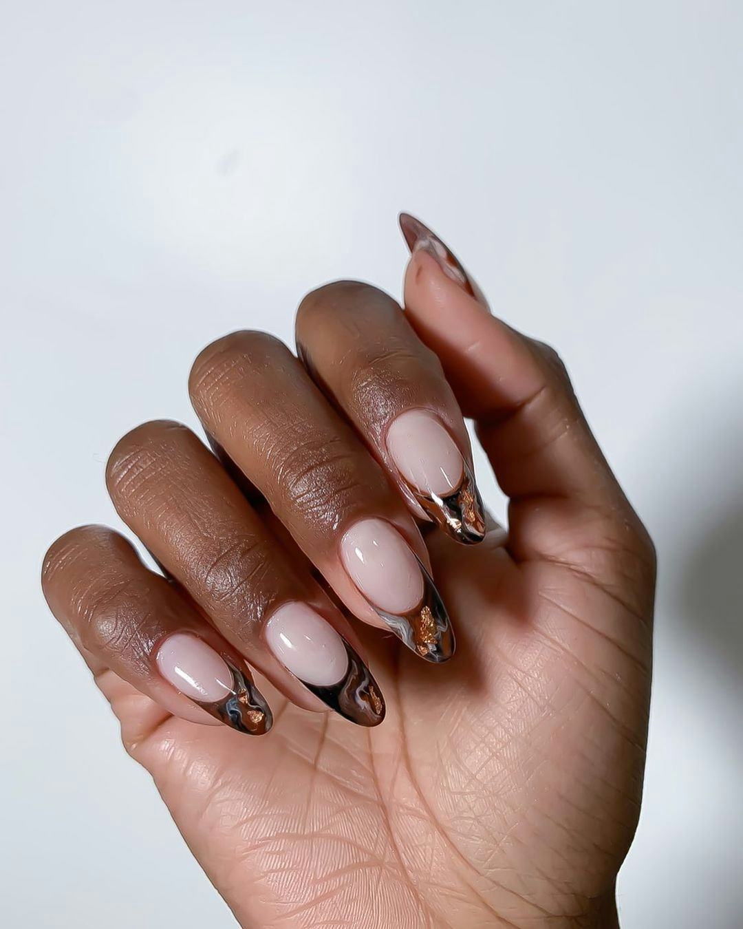 Brown marbled French tip nails are on-trend for fall 2024.