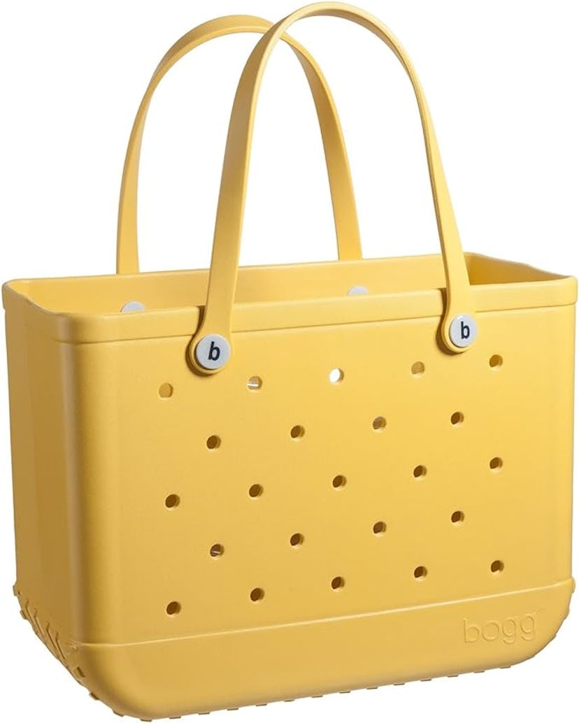 A bright yellow tote bag with perforated sides and sturdy, rounded handles. The bag features a smoot...