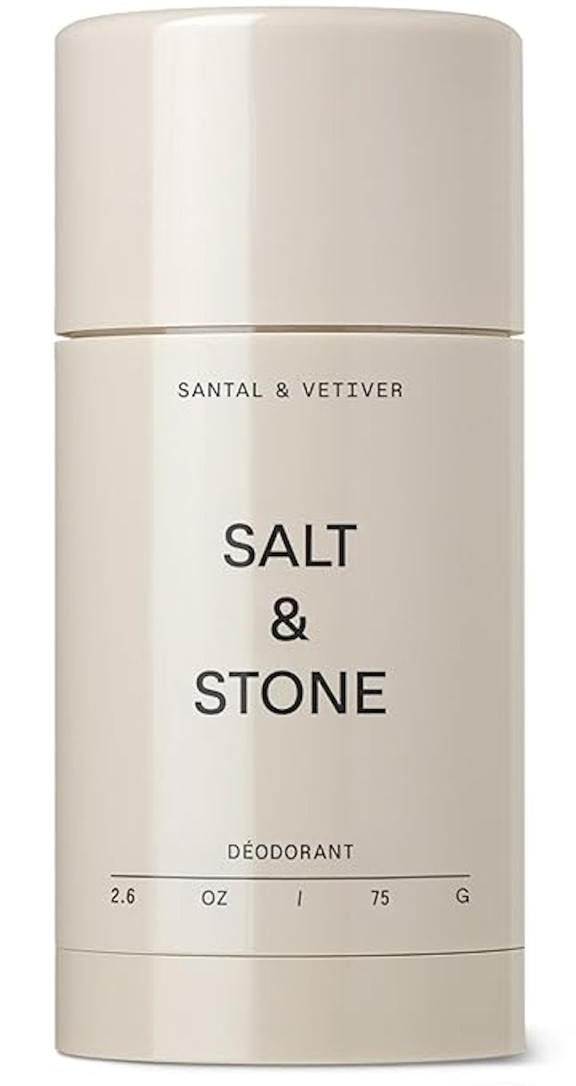 A simple, elegant deodorant stick with a cream-colored cylindrical container. It reads "SALT & STONE...