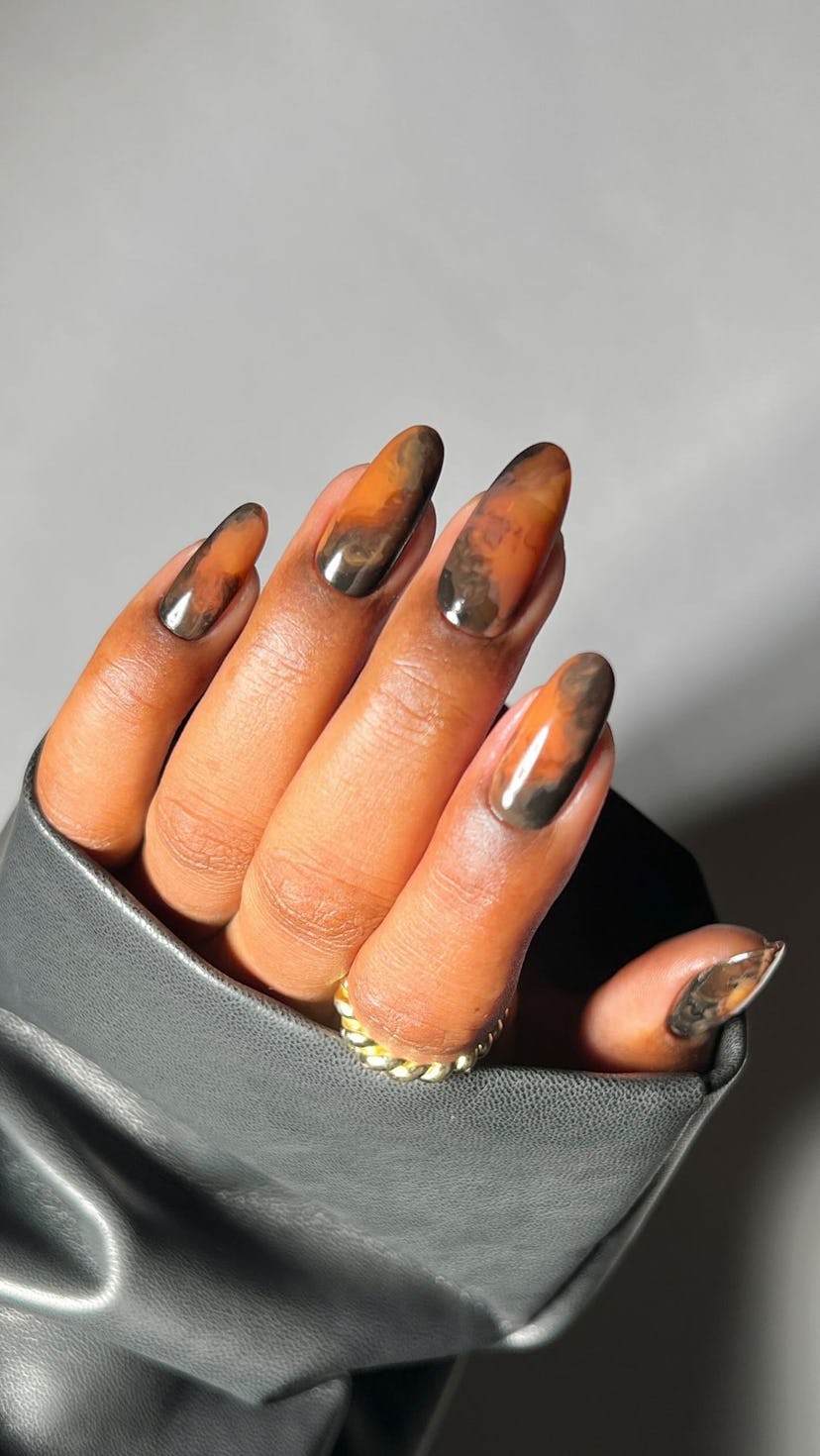 Swirled latte nail are is on-trend for fall 2024.