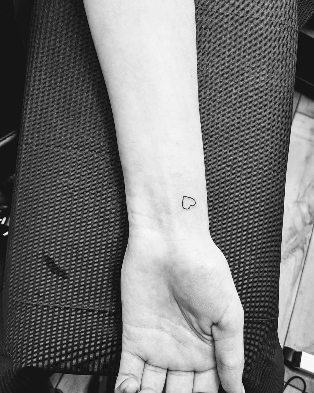 Tiny heart tattoos are on-trend for fall 2024.