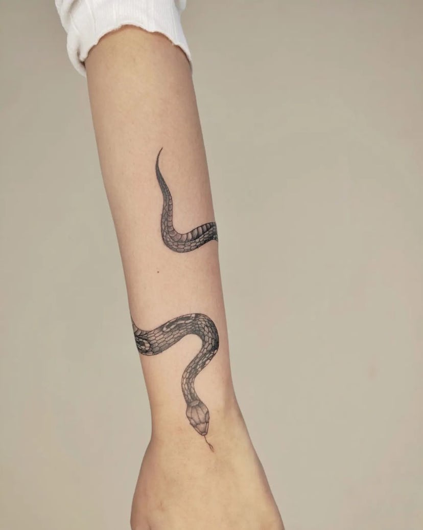Snake tattoos are on-trend for fall 2024.
