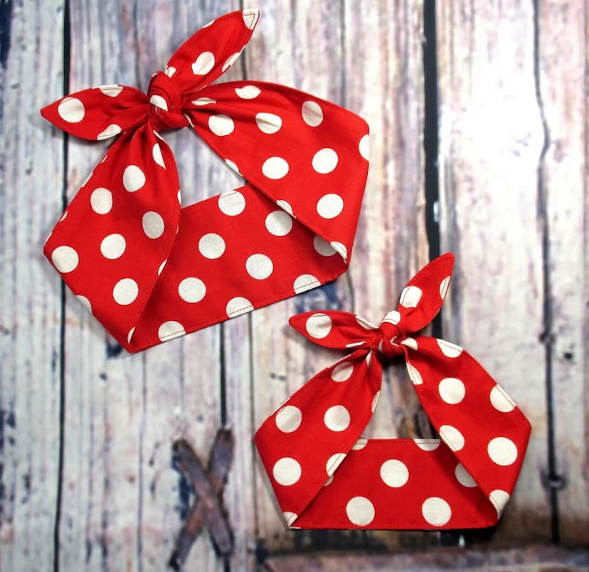 A pair of red hairbands featuring white polka dots, one larger and tied in a bow, and a smaller vers...