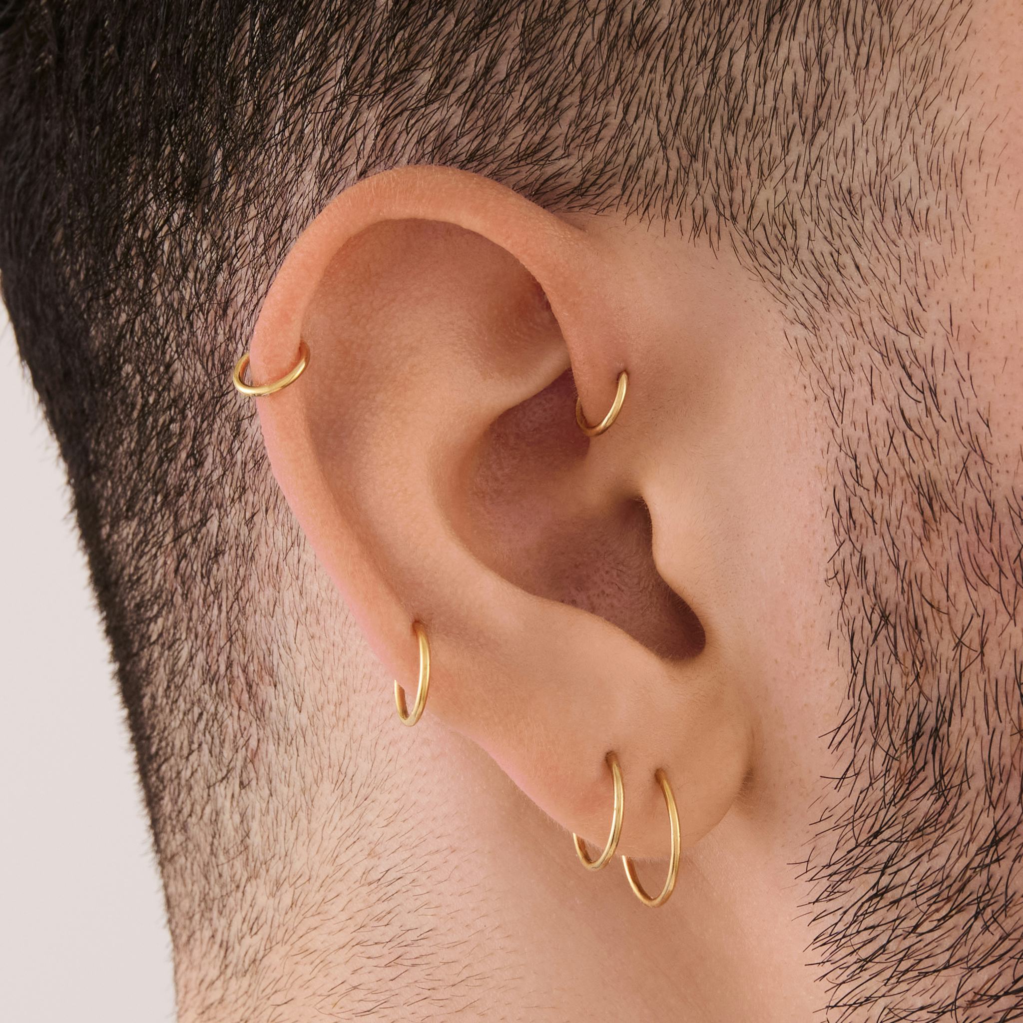 Conch piercings with simple hoops are on-trend for fall 2024.