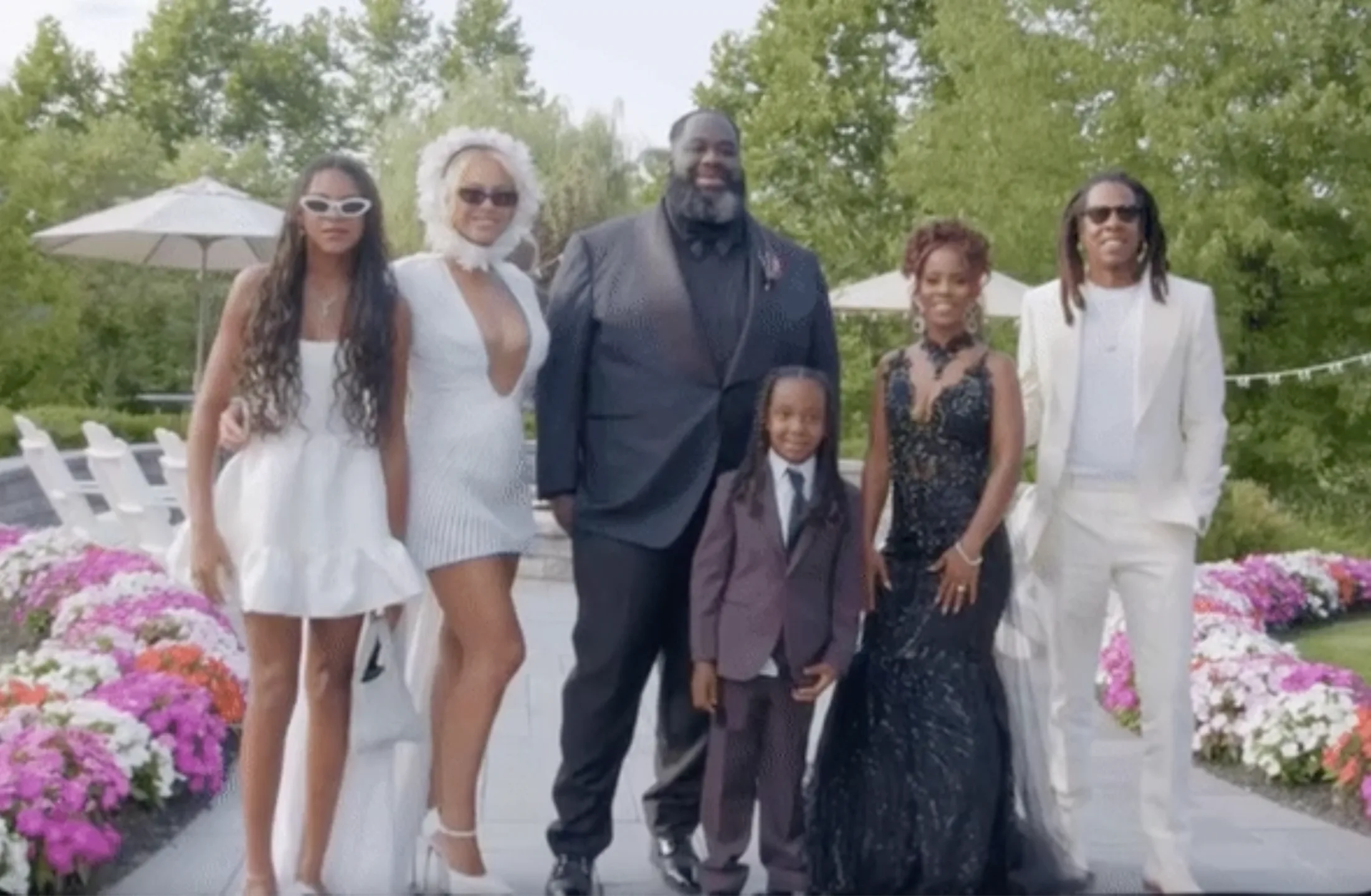 Beyoncé Wore A Plunging White Minidress & Ruffled Headpiece To A Wedding
