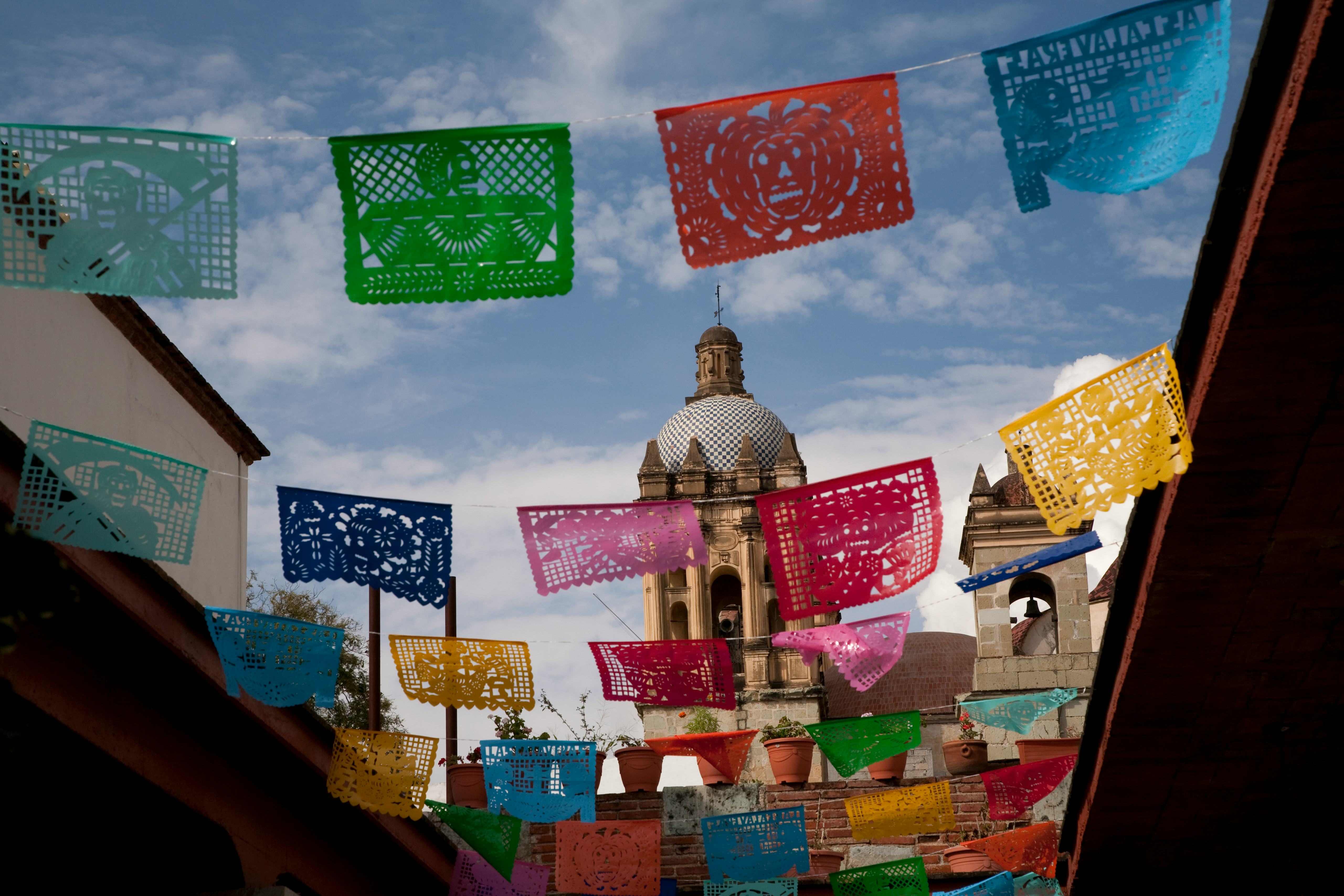 North America, Mexico, Oaxaca Province, Oaxaca, courtyard adorned with colorful tissue paper cut-out...