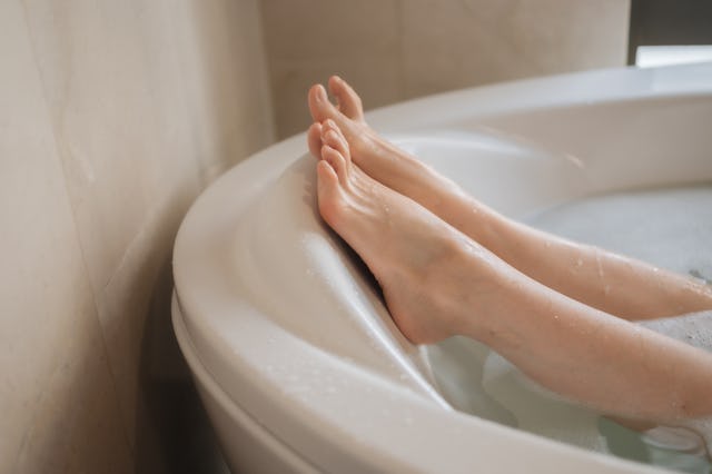 A woman in the bath tub.