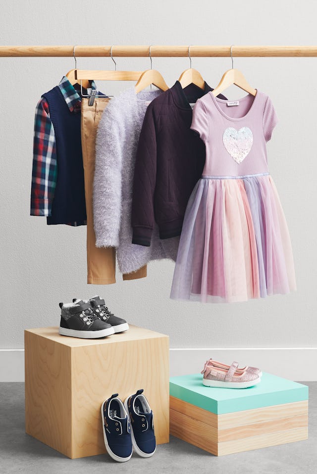 A picture of a wardrobe of new, curated children's clothes.