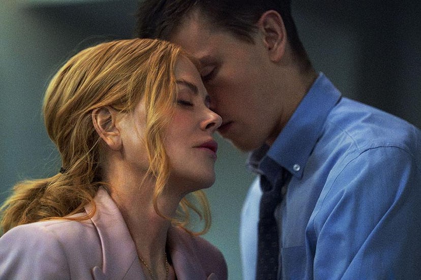 A close-up of a man and woman sharing an intimate moment, their foreheads touching as they close the...
