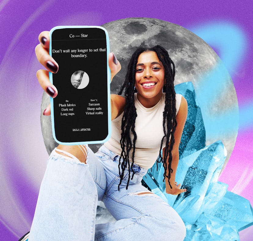 A person with long, curly hair smiles while holding a phone displaying a horoscope app, against a co...