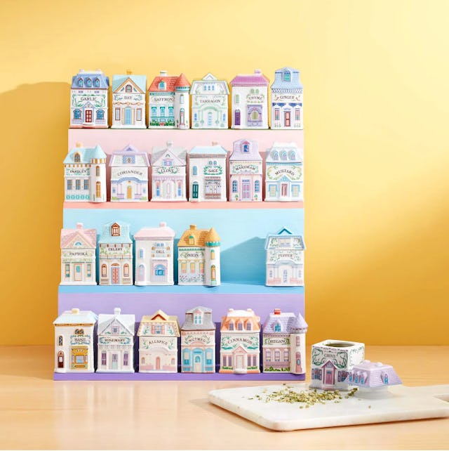 A colorful display of miniature ceramic houses on shelves, featuring intricate designs, with a cutti...
