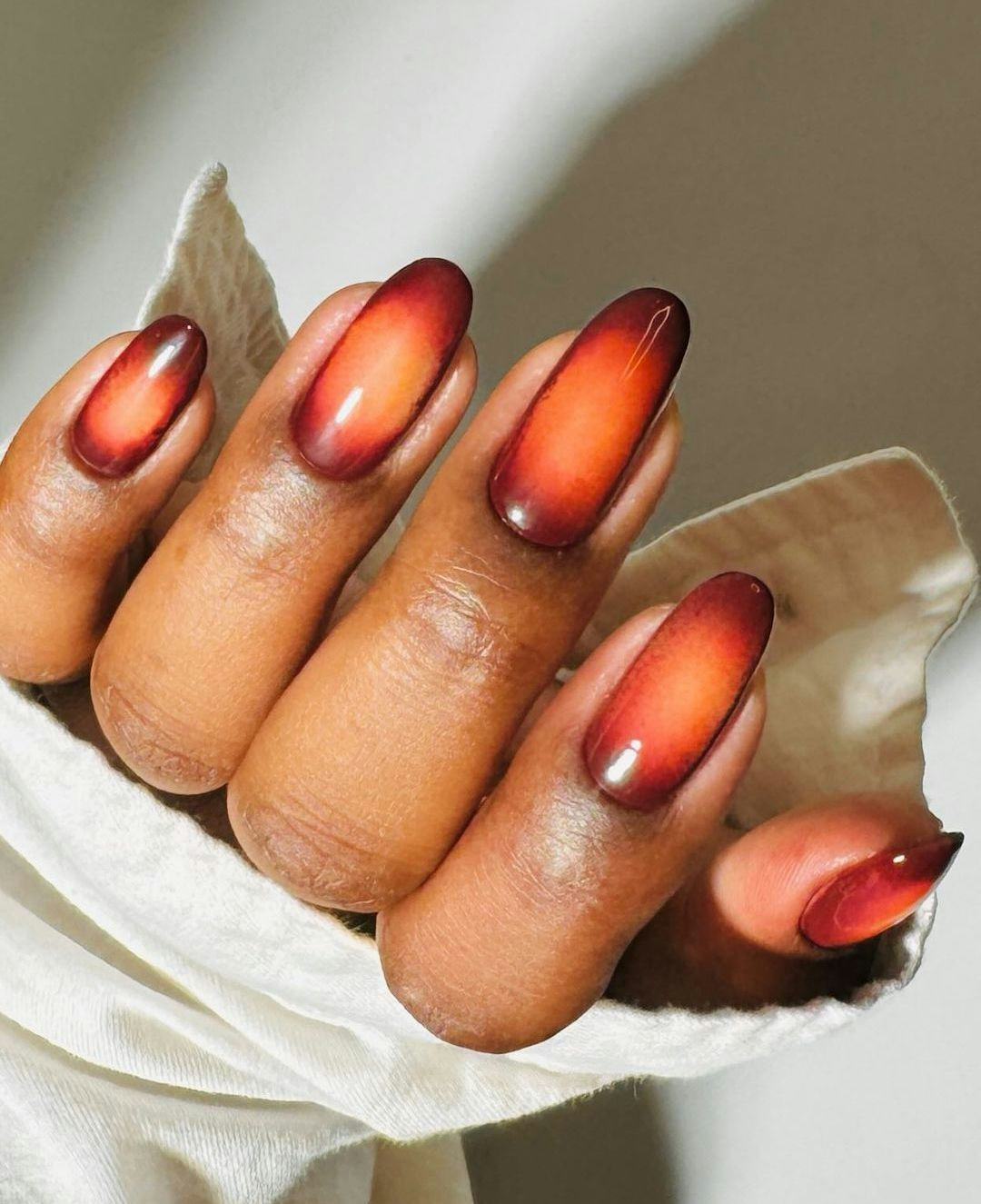Capricorn would wear chocolate brown and warm orange aura nails.