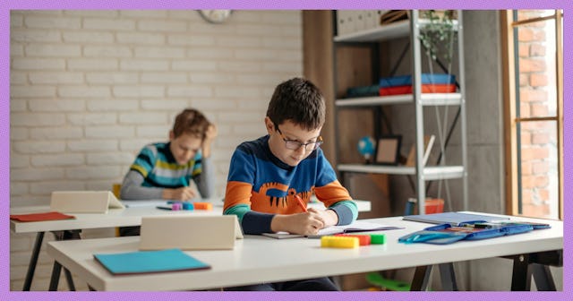 A boy studying at a desk at school. Are attendance policies getting out of control?