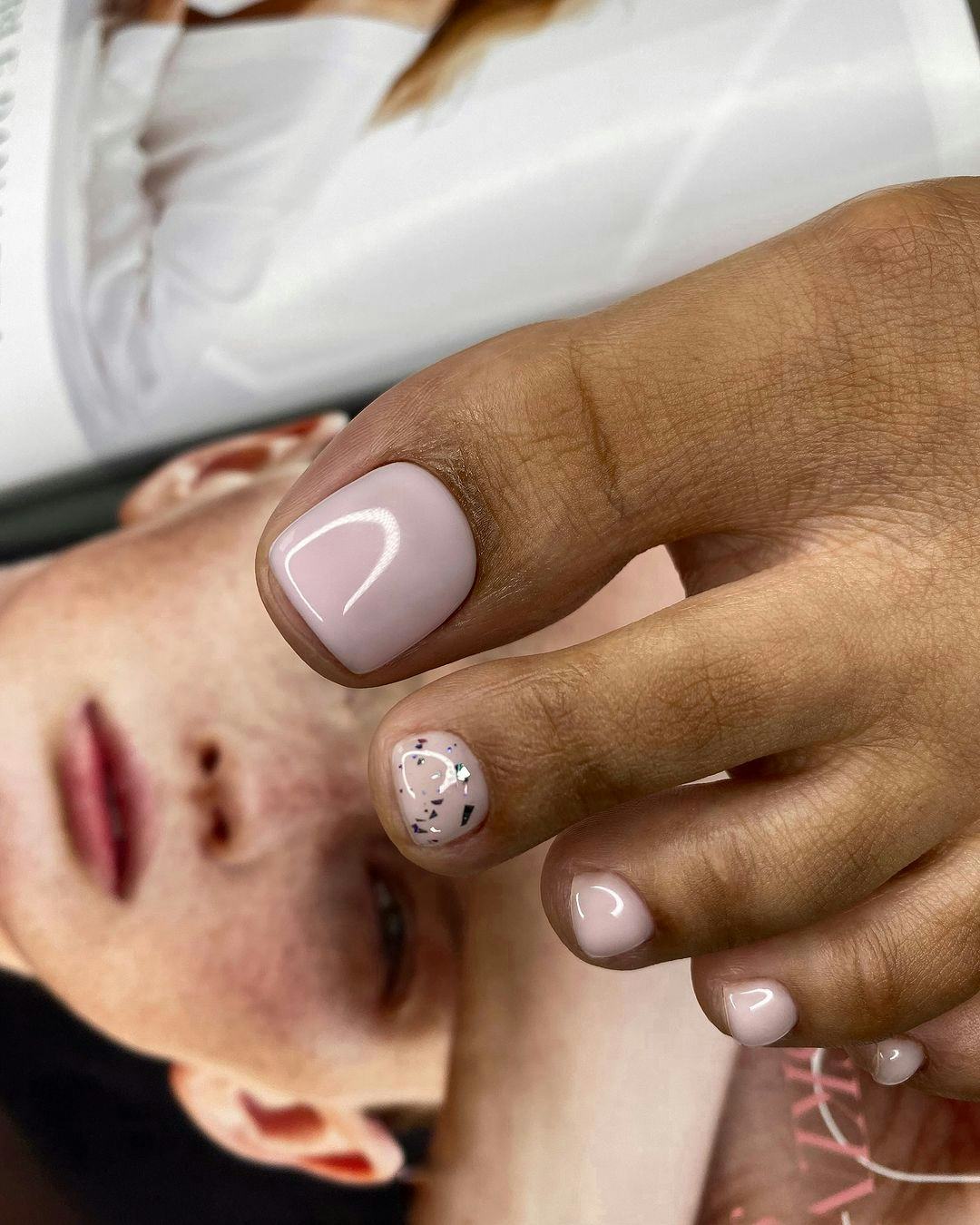 Neutral mauve polish with silver leaf is the perfect pedicure for Libra season 2024.