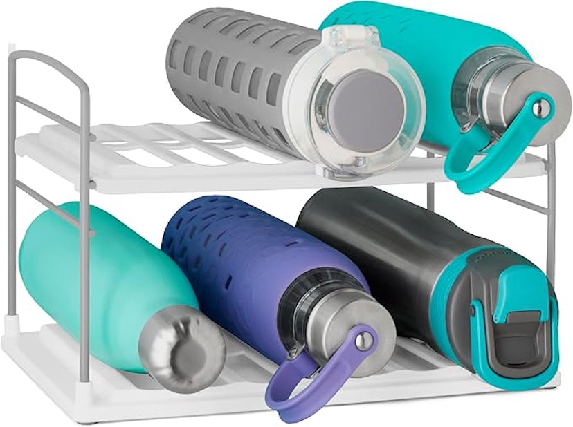 A rack holding five colorful water bottles in various sizes and designs, including teal, gray, purpl...