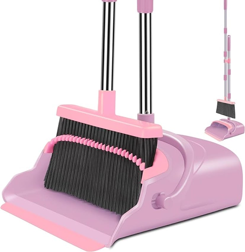 A purple and pink dustpan and broom set, featuring a large broom with black bristles and a small han...