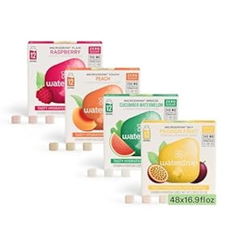 Four boxes of flavored water enhancers arranged in a row, featuring Raspberry, Peach, Cucumber Water...