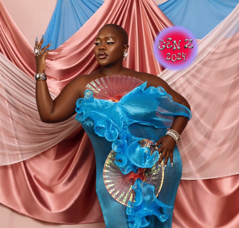 Achieng Agutu stands in front of draped pink and blue silks.