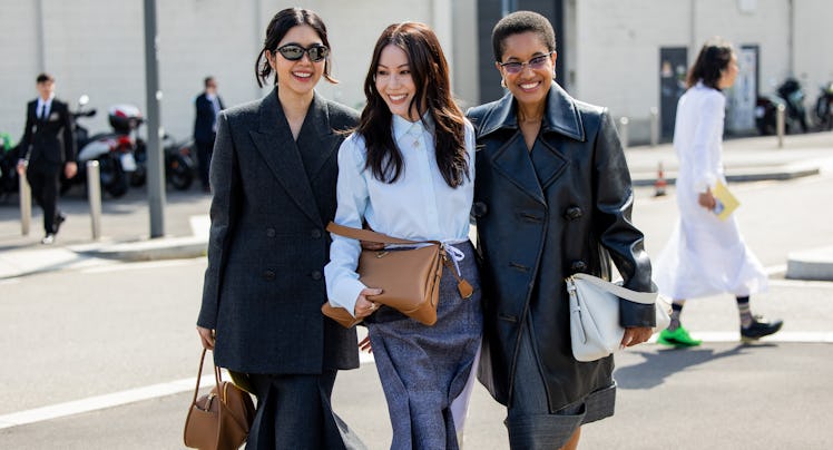 MILAN, ITALY - SEPTEMBER 19: Oranicha Krinchai wears grey blazer, skirt, brown bag & Jenny Tsang war...