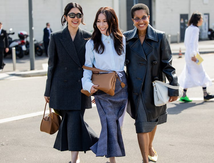 MILAN, ITALY - SEPTEMBER 19: Oranicha Krinchai wears grey blazer, skirt, brown bag & Jenny Tsang war...