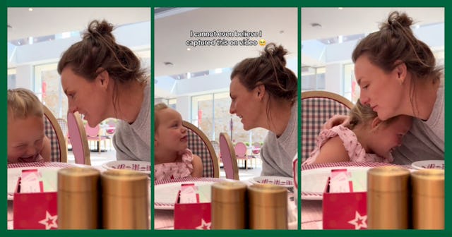 A woman and a young girl share a joyful moment at a table, smiling and leaning towards each other, f...