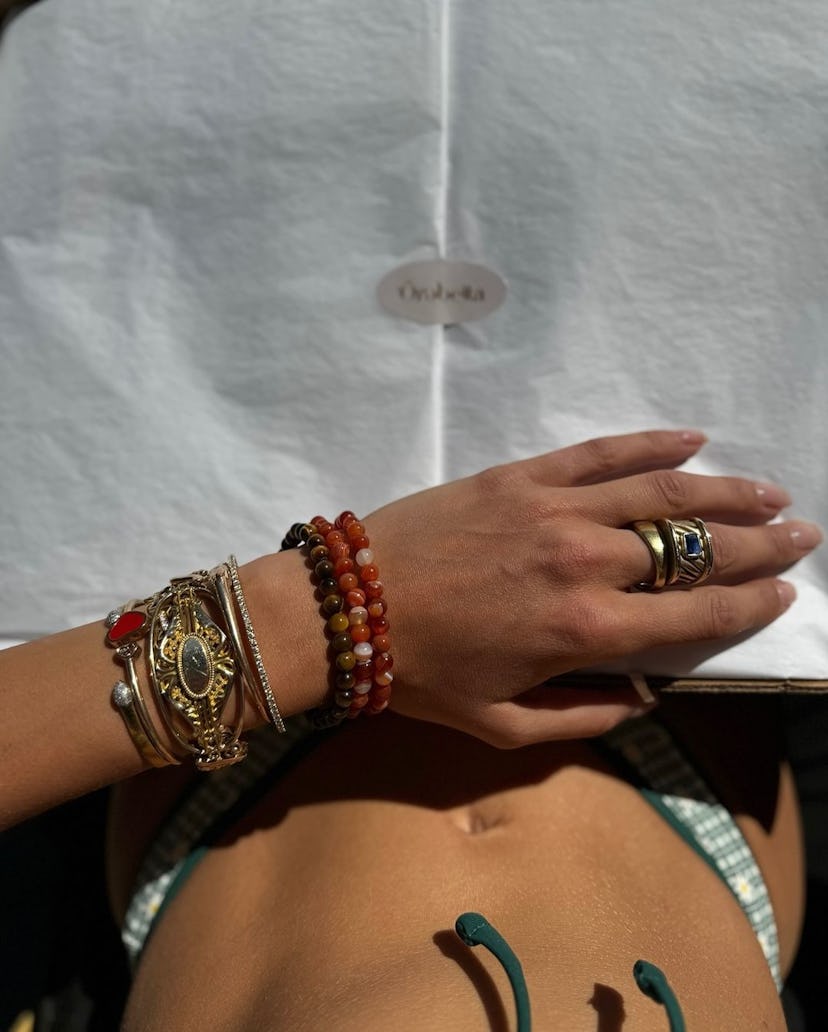 Bella Hadid wears a green patterned bikini.