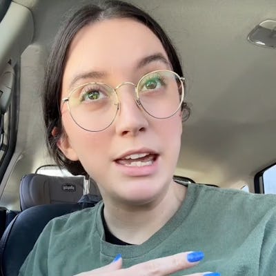 A person with glasses and blue nail polish gestures while speaking in a car, sharing thoughts about feeling drained. The caption emphasizes emotional fatigue.