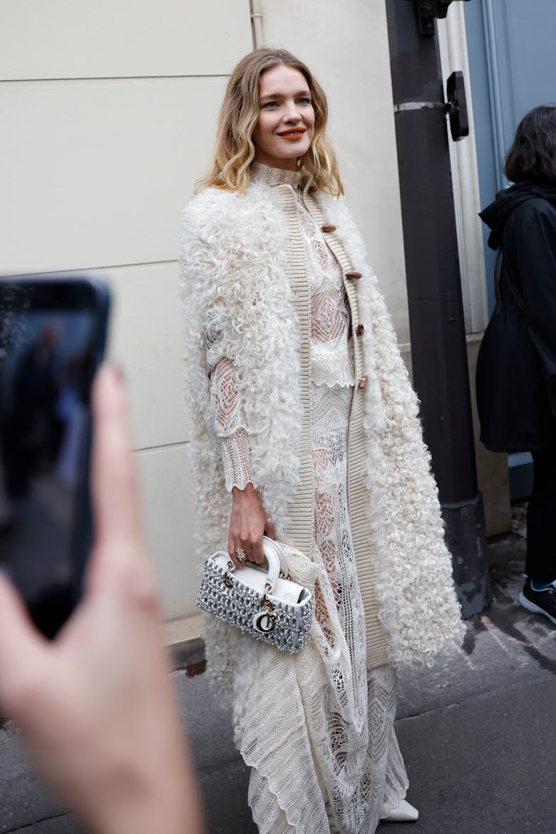PARIS, FRANCE - SEPTEMBER 24: Natal'ja Vodjanova wears white lace top with matching skirt, white fur...