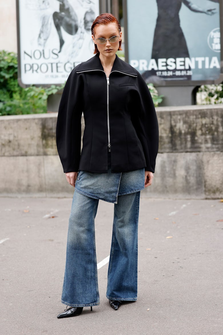 PARIS, FRANCE - SEPTEMBER 24: Meredith Duxbury wears black jacket, blue denim pants, black heels, ou...