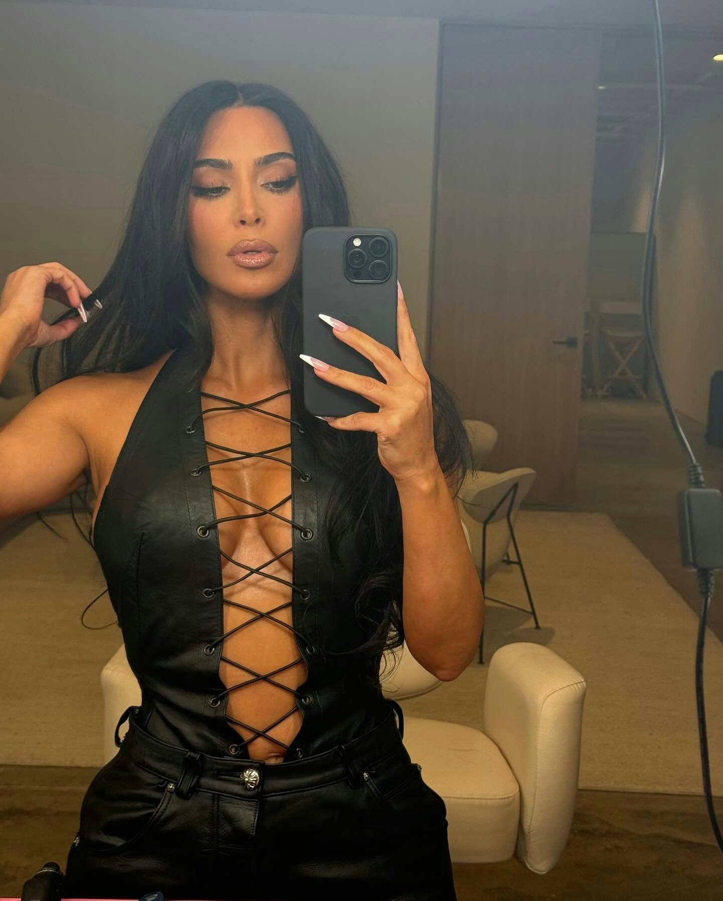 Kim Kardashian Instagram: reality star shares plunging leather look.
