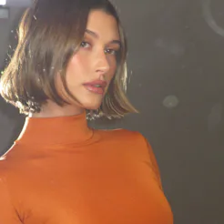 Hailey Bieber just entered her new mom era with "toasted caramel" nails and a diamond-studded mom ri...