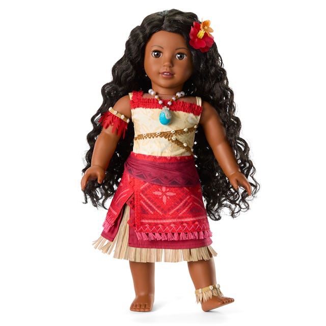A Moana-inspired doll with long, dark curly hair, wearing a vibrant red and beige outfit adorned wit...