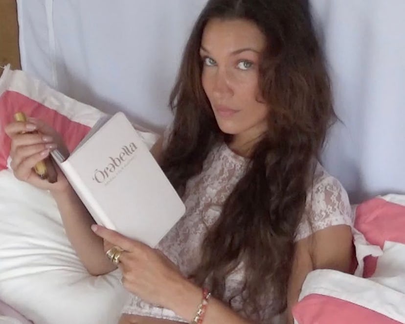 Bella Hadid wears a white lace top and underwear.