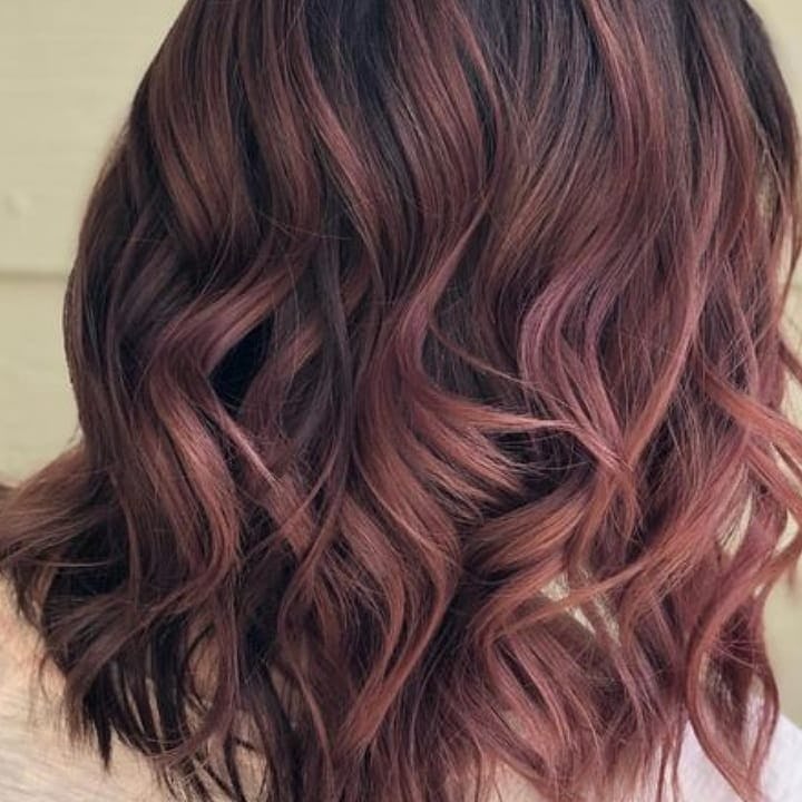 Strawberry brunette hair colors are on-trend for fall 2024.