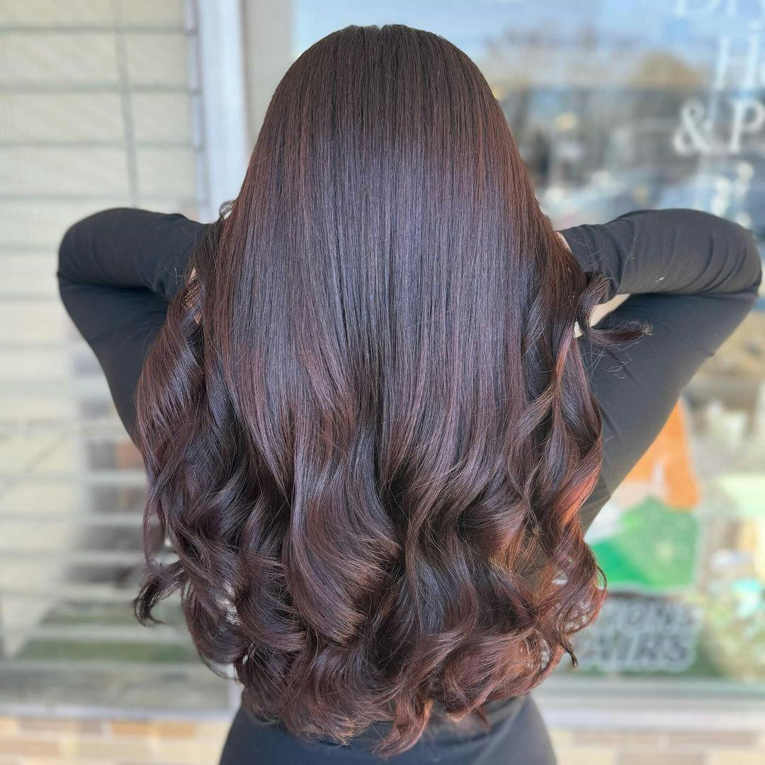 Warm-toned chocolate hair is on-trend for fall 2024.
