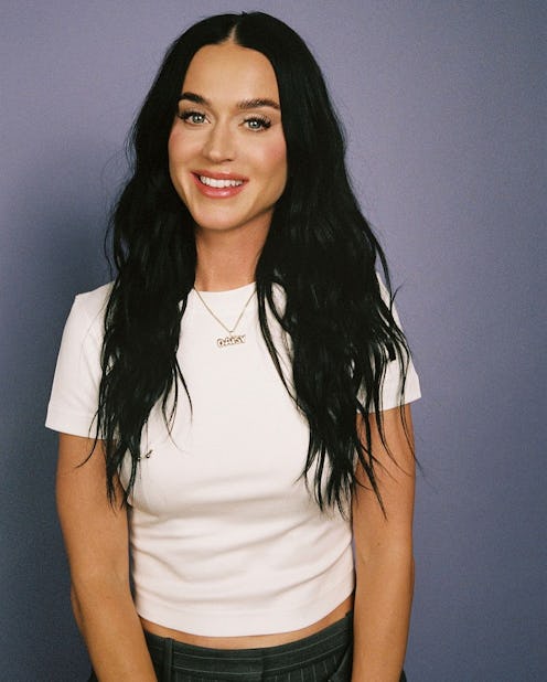 Katy Perry wearing a white short-sleeved T-shirt on the 'Call Her Daddy' Podcast.. 