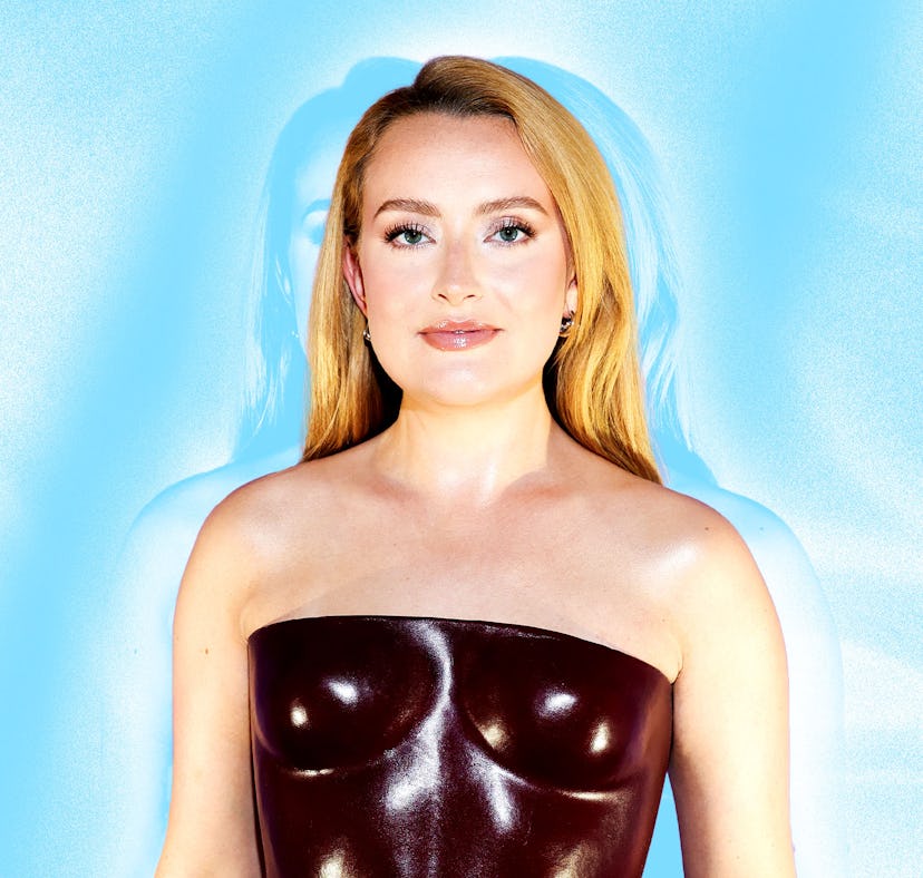 A person wearing a strapless, glossy brown top stands in front of a light blue background, exuding c...