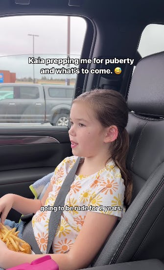 A young girl sits in a car, wearing a floral shirt and enjoying fries. Text on the image humorously discusses puberty and behavior changes.