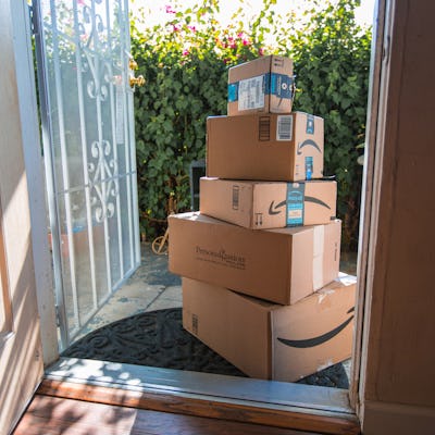 Image of an Amazon packages. Amazon is an online company and is the largest retailer in the world. Cardboard package delivery at front door during the holiday season. shipping package parcel box on wooden floor with protection paper inside. Amazon.com went online in 1995 and is now the largest online retailer in the world.