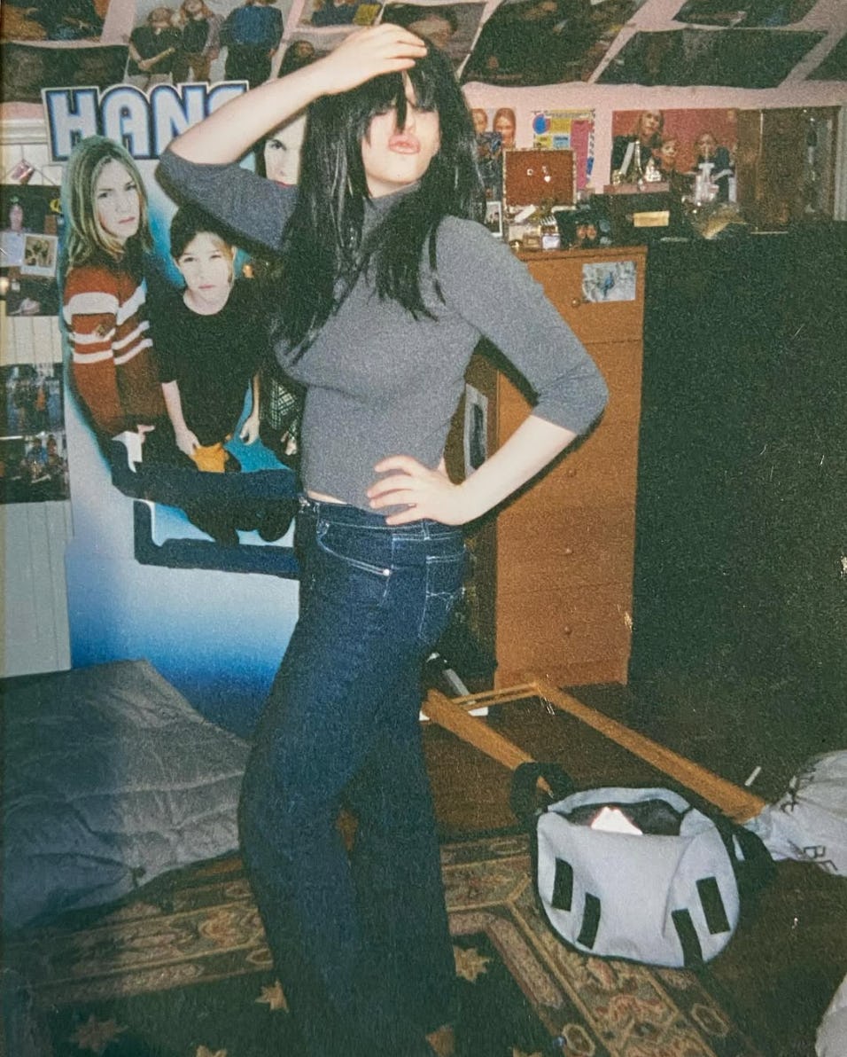 Kat Dennings in her teens with a Hansen poster in the background, via Instagram