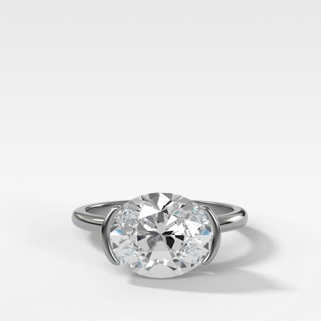 East West Half Bezel Solitaire Engagement Ring With Oval Cut Diamond