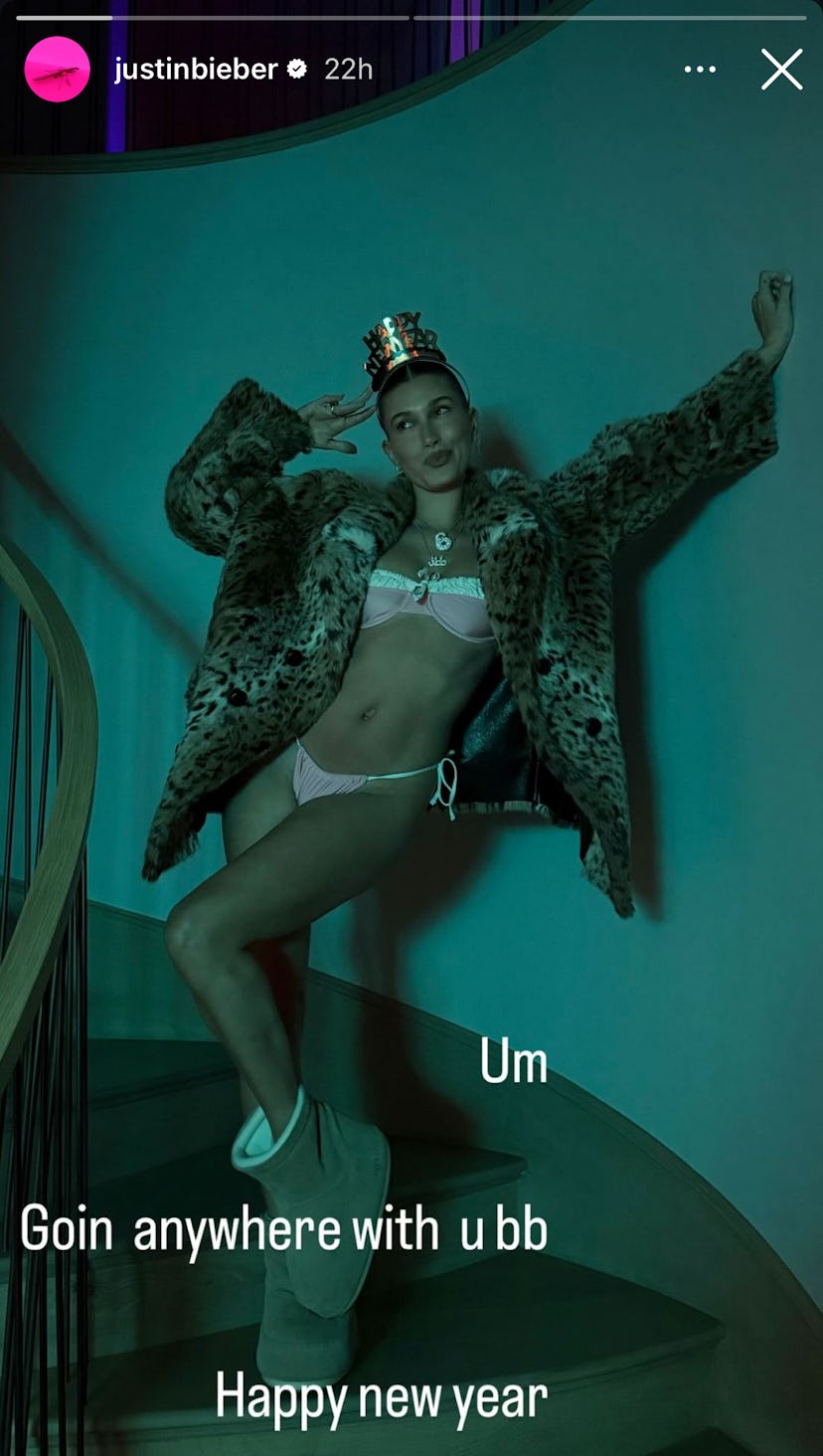 Hailey Bieber wears a pink bikini with a fur coat.