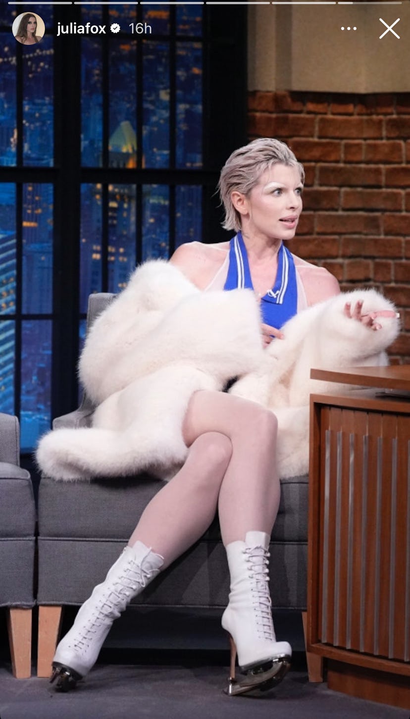 Julia Fox wears a sleeves top and white coat.