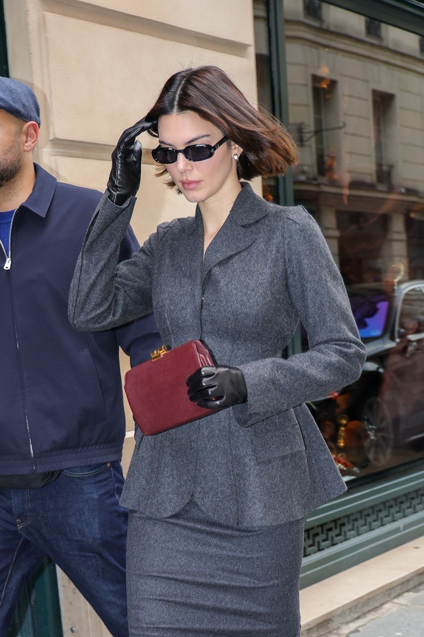 Kendall Jenner wearing a grey skirt suit