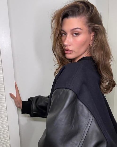 Hailey Bieber wears a black jacket.
